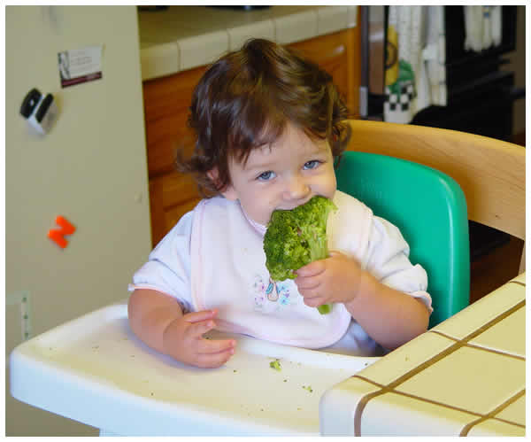 Ellie Munshi munches on farm broccoli